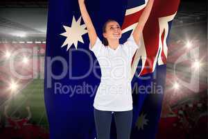 Excited football fan in white cheering holding australia flag