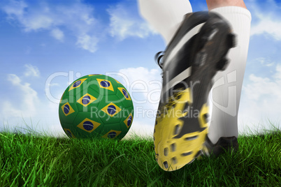 Football boot kicking brasil ball