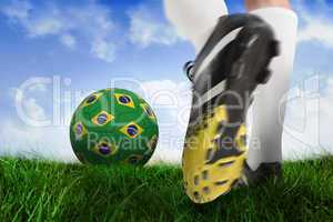 Football boot kicking brasil ball