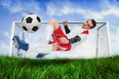 Football player in white kicking the ball