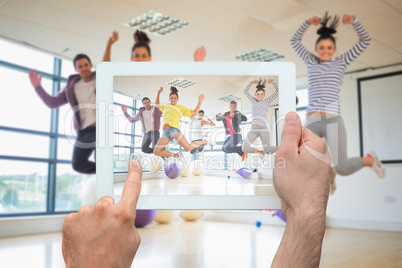 Composite image of hand holding tablet pc