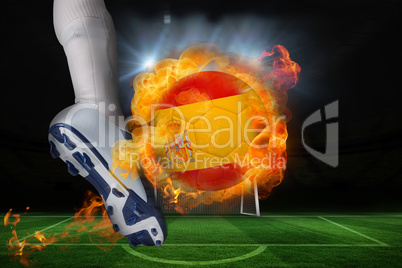 Football player kicking flaming spain flag ball