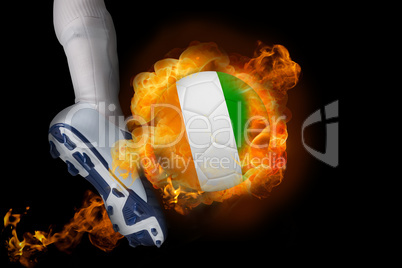 Football player kicking flaming ivory coast ball