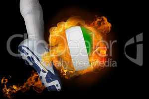 Football player kicking flaming ivory coast ball