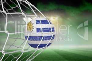 Football in uruguay colours at back of net