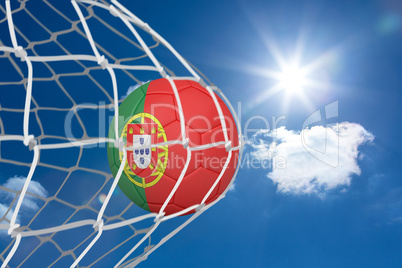 Football in portugal colours at back of net