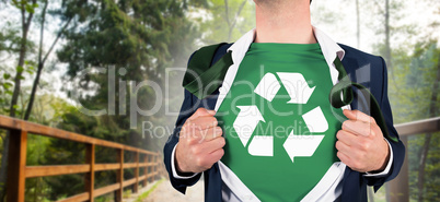 Composite image of businessman opening shirt in superhero style