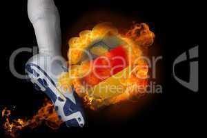 Football player kicking flaming germany ball