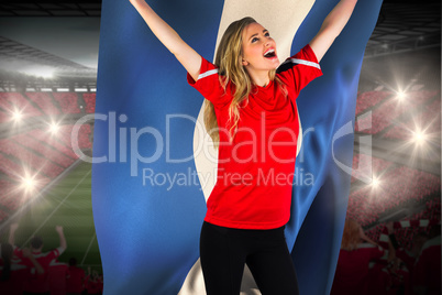 Cheering football fan in red holding honduras flag