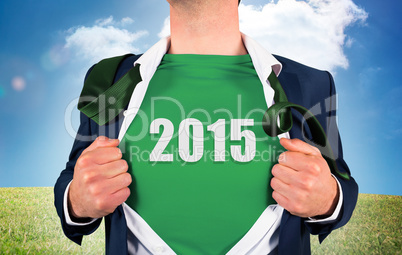 Composite image of businessman opening shirt in superhero style