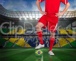 Football player standing with brasil ball