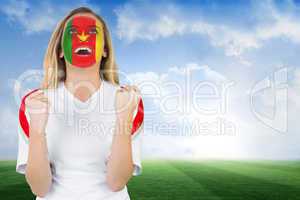 Excited cameroon fan in face paint cheering