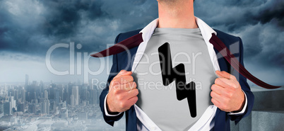 Composite image of businessman opening shirt in superhero style