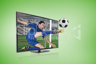 Football player in blue kicking ball through tv screen