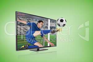 Football player in blue kicking ball through tv screen