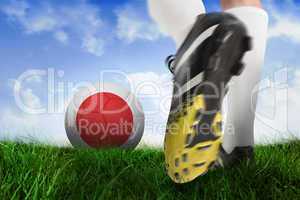 Football boot kicking japan ball