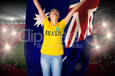 Excited football fan in brasil tshirt holding australia flag