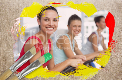 Composite image of spinning class in the gym