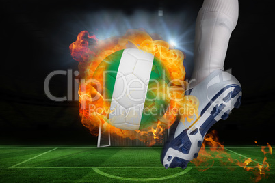 Football player kicking flaming nigeria flag ball
