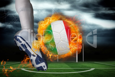 Football player kicking flaming italy flag ball