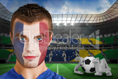 Serious young france fan with face paint