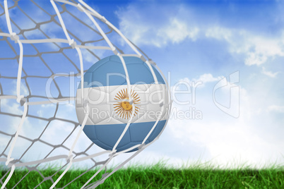 Football in argentina colours at back of net