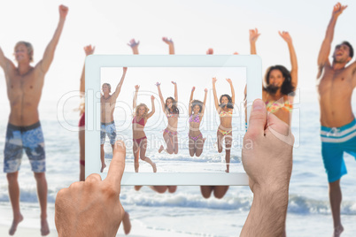 Composite image of hand holding tablet pc