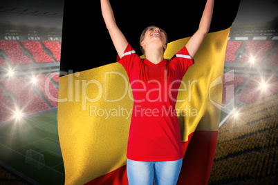 Cheering football fan in red holding belgium flag