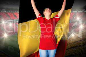 Cheering football fan in red holding belgium flag