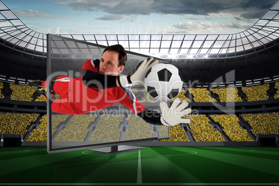 Fit goal keeper saving goal through tv