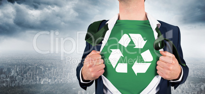 Composite image of businessman opening shirt in superhero style