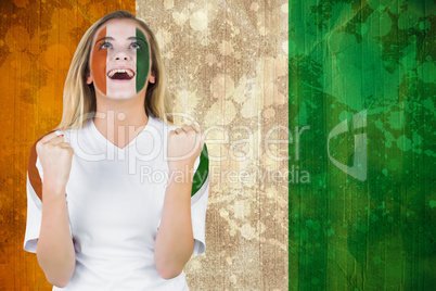 Excited ivory coast fan in face paint cheering