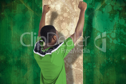 Cheering football fan in green jersey