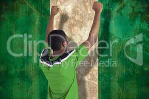 Cheering football fan in green jersey