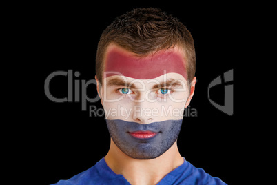 Serious young netherlands fan with facepaint