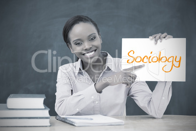 Happy teacher holding page showing sociology