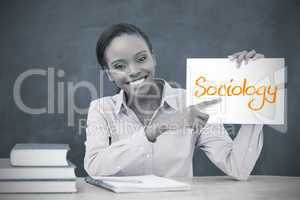 Happy teacher holding page showing sociology