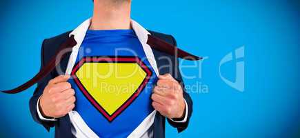 Composite image of businessman opening shirt in superhero style