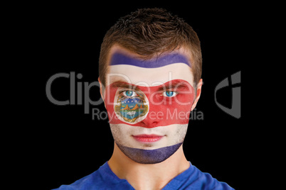Serious young costa rica fan with facepaint