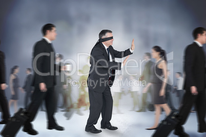 Composite image of mature businessman in a blindfold