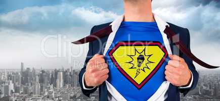 Composite image of businessman opening shirt in superhero style