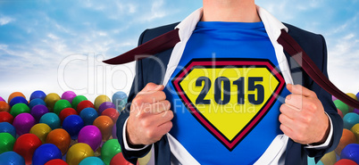 Composite image of businessman opening shirt in superhero style