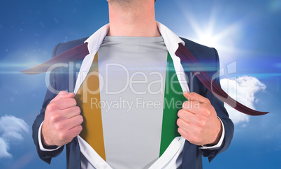 Businessman opening shirt to reveal ivory coast flag