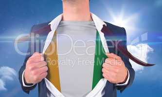 Businessman opening shirt to reveal ivory coast flag