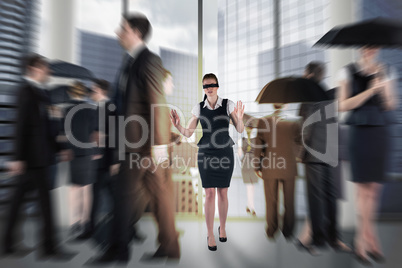 Composite image of redhead businesswoman in a blindfold