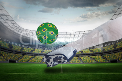 Close up of football player kicking brasil ball