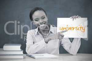 Happy teacher holding page showing university