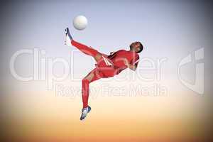 Football player in red kicking