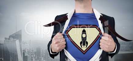 Composite image of businessman opening shirt in superhero style