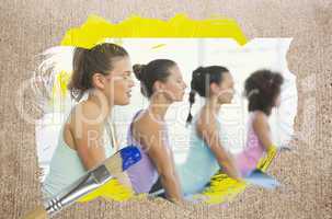 Composite image of yoga class in the gym